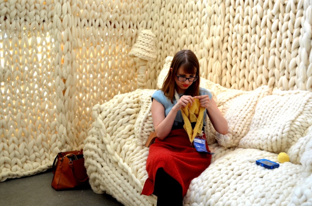 An artist knitting away in her Art Prize Yarn House exhibit...very original and cozy to boot.